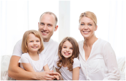 A family of four posing for the camera.