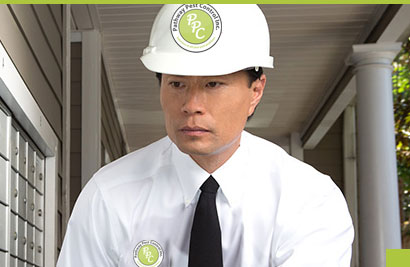 A man in white shirt and hard hat wearing tie.